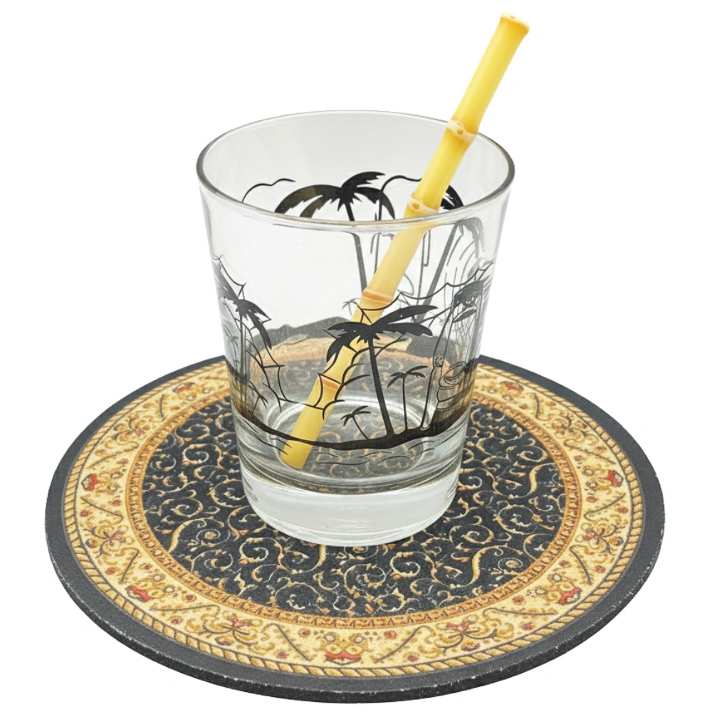 Surfside Sips real yellow bamboo-style glass straw in a tiki-themed cocktail glass, perfect for tropical drinks and sustainable sipping.